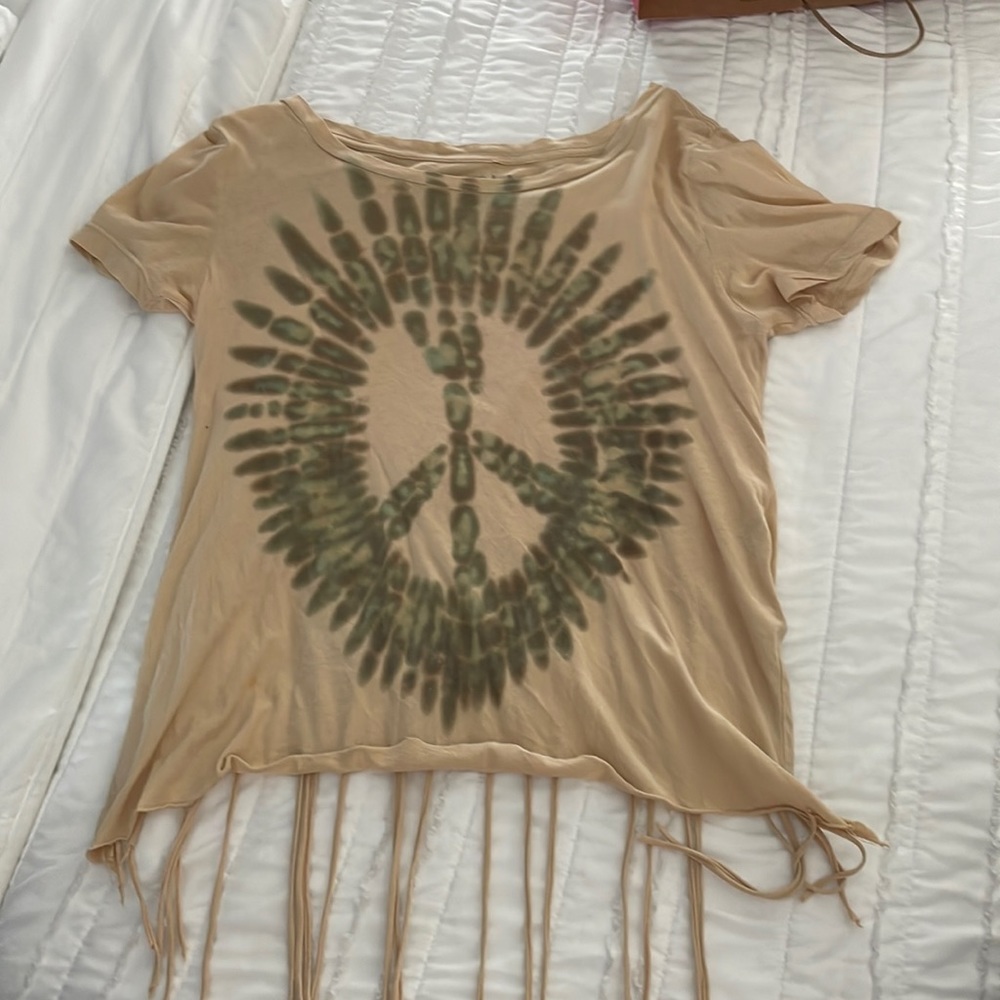 Adorable top with cropped back and hanging fringe